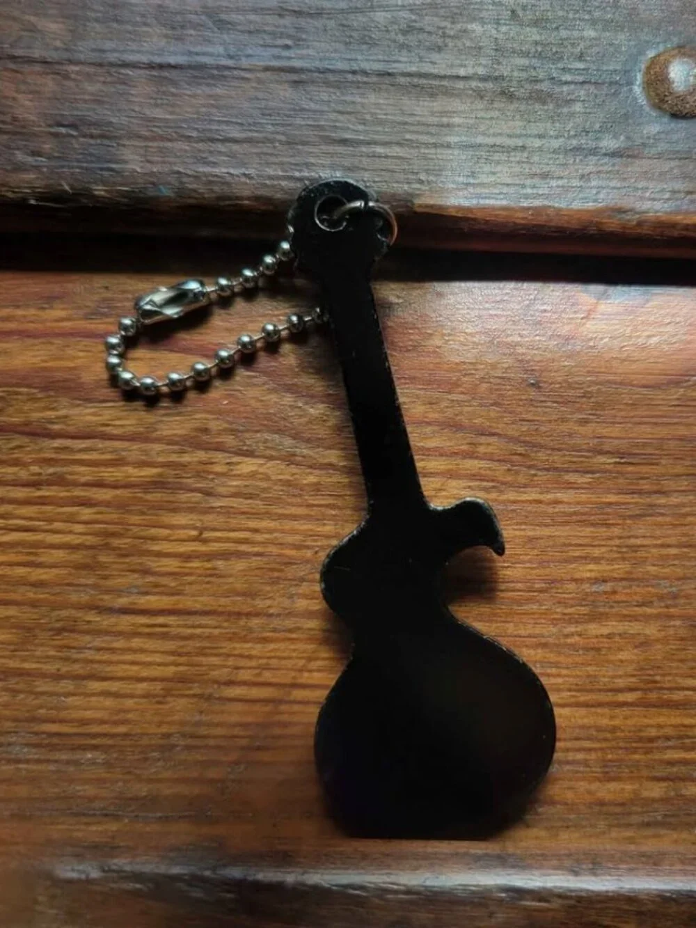 Guitar-Shaped Black Keychain And Promotional Bottle Opener